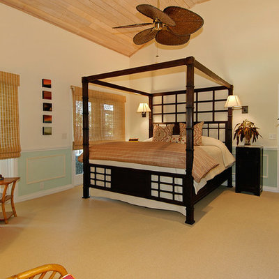 Large island style master carpeted and brown floor bedroom photo in Miami with beige walls and no fireplace