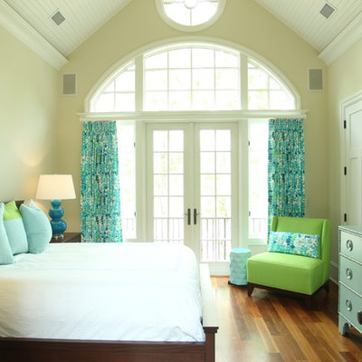 Inspiration for a coastal medium tone wood floor bedroom remodel in Charleston with beige walls