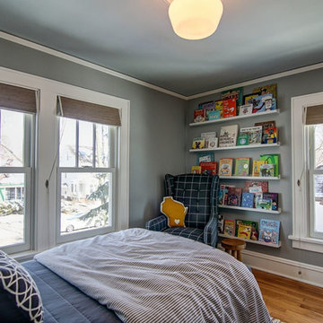 Kids' books become art on wall-mounted shelves in the reading nook.