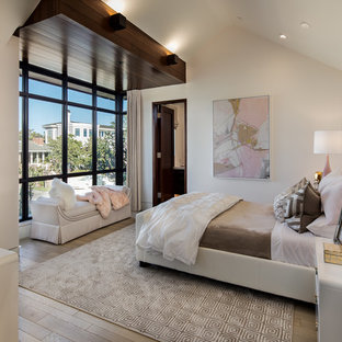 Inspiration for a transitional medium tone wood floor bedroom remodel in Orange County with white walls