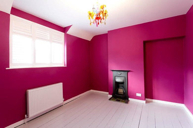 Design ideas for a medium sized contemporary bedroom in Oxfordshire with pink walls and painted wood flooring.