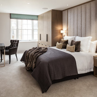 Photo of a medium sized classic master bedroom in London with beige walls, carpet and beige floors.