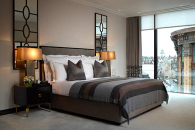 Inspiration for a large contemporary master bedroom in London with beige walls, carpet, no fireplace and beige floors.