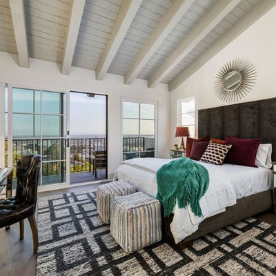 Tuscan master dark wood floor bedroom photo in Los Angeles with white walls and no fireplace