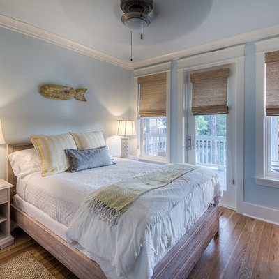 Beach style guest light wood floor bedroom photo in Miami with blue walls