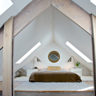 Design ideas for a beach style bedroom in Jacksonville with white walls and plywood floors.