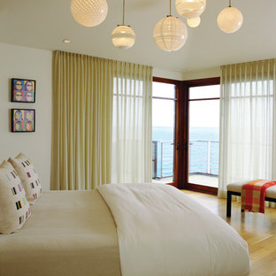 Minimalist light wood floor bedroom photo in Orange County with beige walls