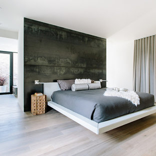 Diseño de dormitorio principal, minimalista, con paredes negras, suelo de madera clara y suelo beige