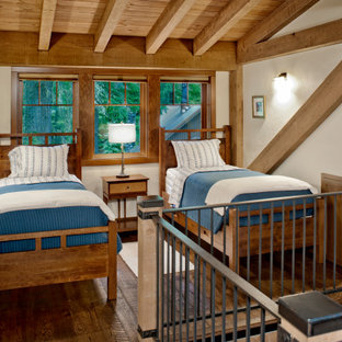 Foto de dormitorio tipo loft, rural, con paredes blancas, suelo de madera oscura y suelo marrón