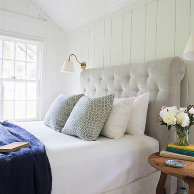 Large beach style master medium tone wood floor and brown floor bedroom photo in Portland Maine with white walls and no fireplace