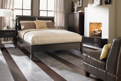シアトルにある中くらいなトランジショナルスタイルのおしゃれな主寝室 (グレーの壁、ラミネートの床、標準型暖炉、茶色い床)