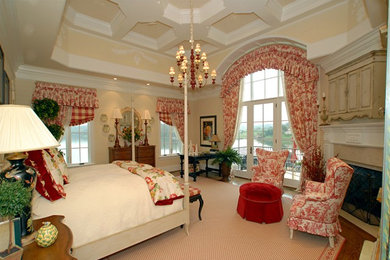 Example of a large classic master carpeted bedroom design in Other with beige walls, a corner fireplace and a stone fireplace