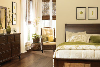 Inspiration for a timeless master dark wood floor and brown floor bedroom remodel in Cleveland with beige walls