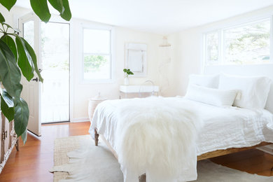 Bedroom - small scandinavian master medium tone wood floor and beige floor bedroom idea in Santa Barbara with white walls and no fireplace