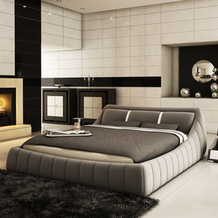 Inspiration for a large modern master bedroom in Toronto with white walls, marble floors, a standard fireplace, a metal fireplace surround and white floor.
