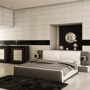 Foto de dormitorio principal, moderno, grande, con paredes blancas, chimenea tradicional, marco de chimenea de metal, suelo de cemento y suelo gris