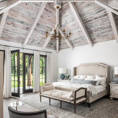 Large elegant master medium tone wood floor and brown floor bedroom photo in Nashville with white walls