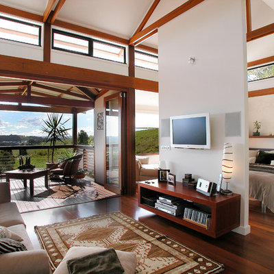 Example of a trendy master dark wood floor bedroom design in Brisbane with white walls