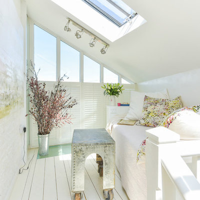 Small cottage chic guest painted wood floor and white floor bedroom photo in Sussex with white walls