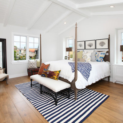 Bedroom - coastal medium tone wood floor bedroom idea in Orange County with white walls and no fireplace