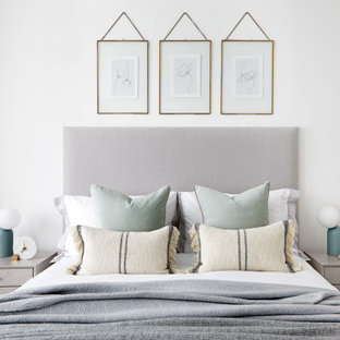 Photo of a medium sized contemporary master bedroom in London with white walls.