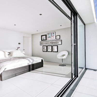 Trendy white floor bedroom photo in Hampshire with gray walls