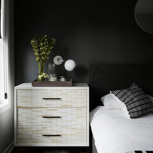 Ejemplo de dormitorio principal, minimalista, de tamaño medio, sin chimenea, con paredes grises, suelo de madera oscura, marco de chimenea de baldosas y/o azulejos y suelo negro