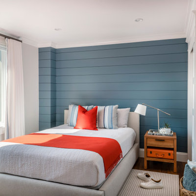 Inspiration for a coastal dark wood floor, brown floor and shiplap wall bedroom remodel in Boston with blue walls