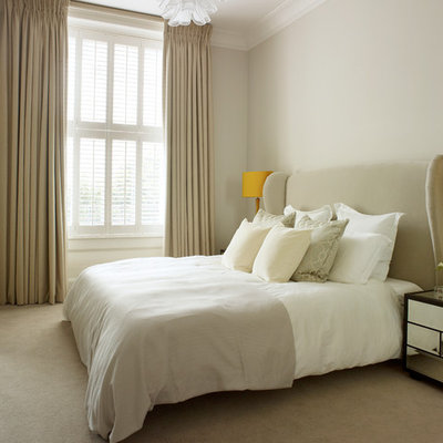 Example of a small trendy master carpeted bedroom design in London with beige walls
