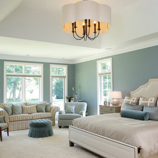 Example of a classic carpeted bedroom design in Cleveland with blue walls