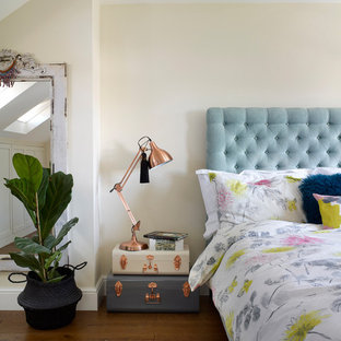Photo of a romantic bedroom in London with beige walls, dark hardwood flooring and brown floors.