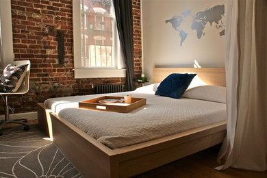Photo of a modern loft bedroom in New York with beige walls.