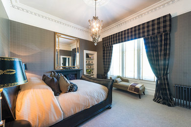 This is an example of a traditional master bedroom in Edinburgh.