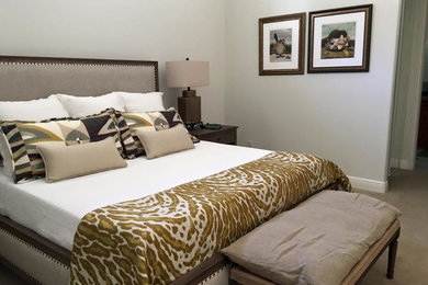 Example of a mid-sized eclectic master carpeted bedroom design in Newark with white walls