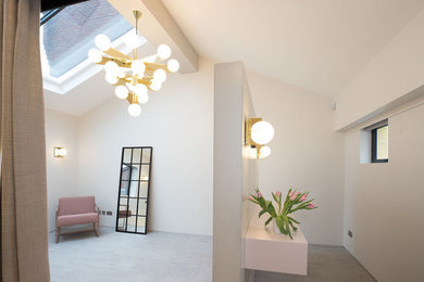 Inspiration for a medium sized modern master and grey and pink bedroom in London with pink walls, porcelain flooring, no fireplace and grey floors.