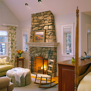 Large arts and crafts master dark wood floor bedroom photo in Boston with white walls, a standard fireplace and a stone fireplace