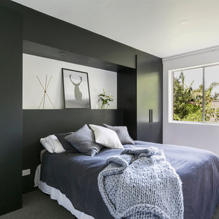 Design ideas for a scandinavian bedroom in Sydney with black walls, carpet and grey floor.