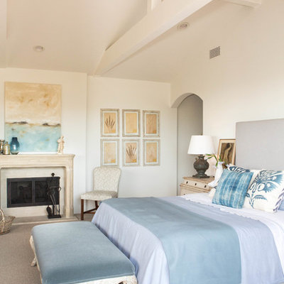 Bedroom - large coastal master carpeted bedroom idea in San Francisco with white walls, a standard fireplace and a plaster fireplace
