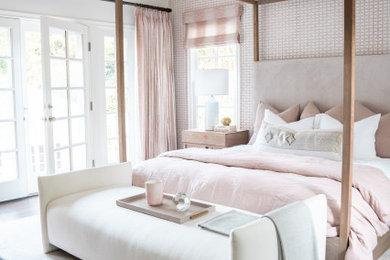 Beach style dark wood floor and brown floor bedroom photo in Orange County with pink walls