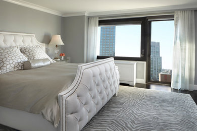 Transitional master bedroom in New York with grey walls.