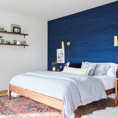 Beach style master light wood floor bedroom photo in Los Angeles with blue walls and no fireplace
