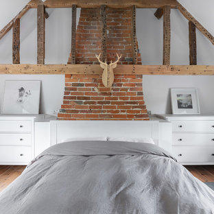 Design ideas for a large rural master bedroom in Oxfordshire with white walls and no fireplace.