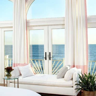 Inspiration for a large coastal master medium tone wood floor bedroom remodel in Boston with pink walls