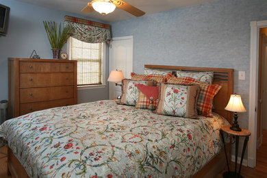 Example of a mid-sized classic guest medium tone wood floor bedroom design in Philadelphia with blue walls and no fireplace