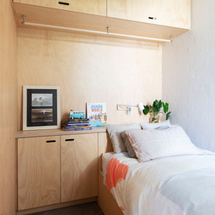 Industrial bedroom in Perth with white walls, concrete floors and grey floor.