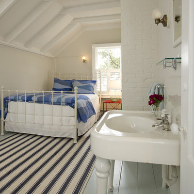 Inspiration for a mid-sized coastal guest painted wood floor and blue floor bedroom remodel in Boston with beige walls and no fireplace