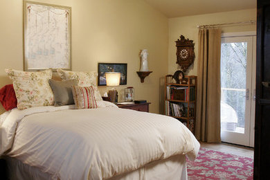 Trendy master medium tone wood floor bedroom photo in Portland with beige walls