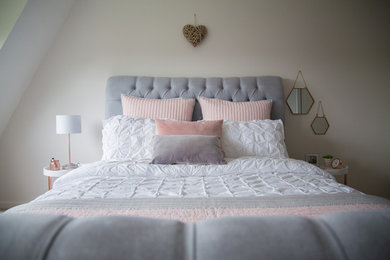 Inspiration for a medium sized contemporary master and grey and pink bedroom in Gloucestershire with white walls, carpet, beige floors and feature lighting.