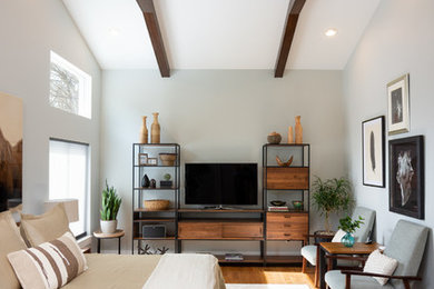 Example of a trendy guest medium tone wood floor and brown floor bedroom design in Detroit with white walls