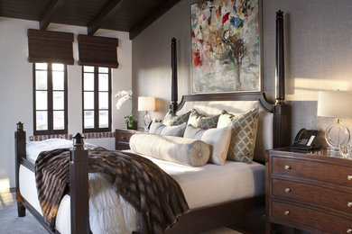 Example of a mid-sized tuscan master dark wood floor and brown floor bedroom design in Los Angeles with no fireplace and gray walls